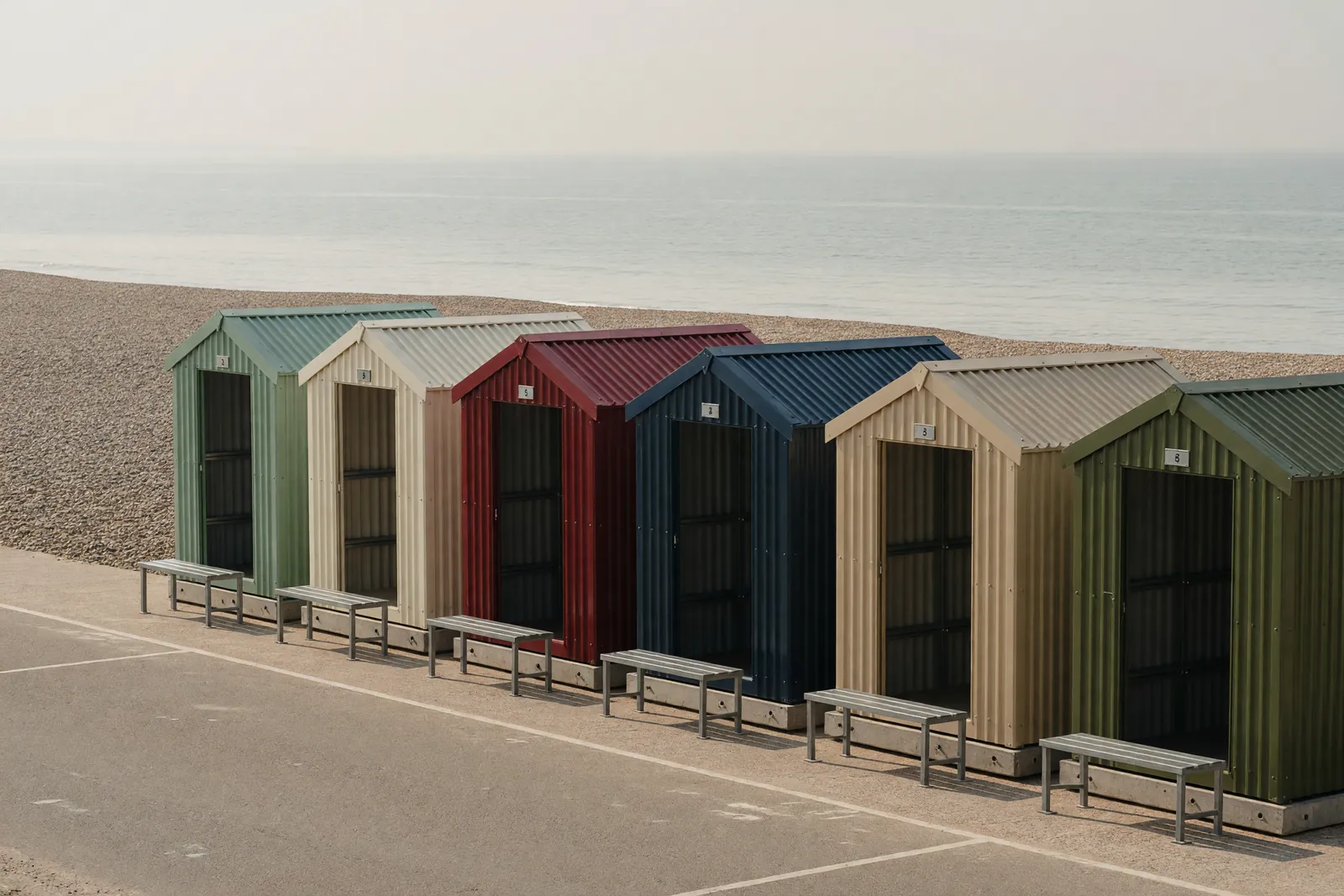 Concept visualisation, not a photograph: beach hut row in corrugated powder-coated steel.